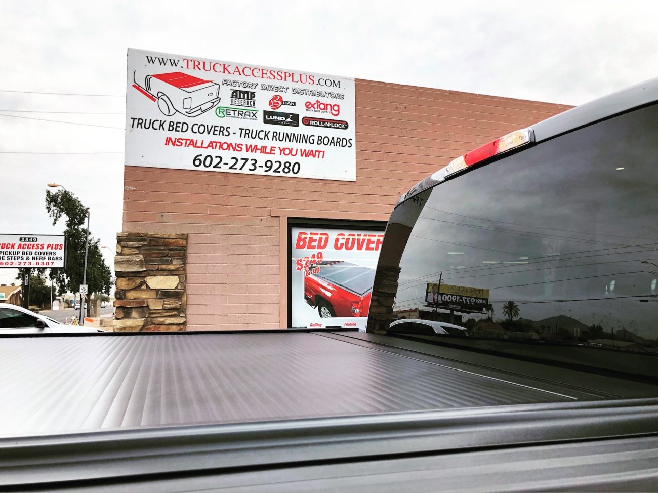 Retrax Cover on Truck in front of Truck Accessories Plus Building