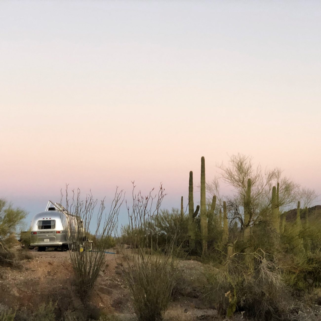 Airstream with solar panels raised at sunset in Sonoran Desert near Ajo, AZ