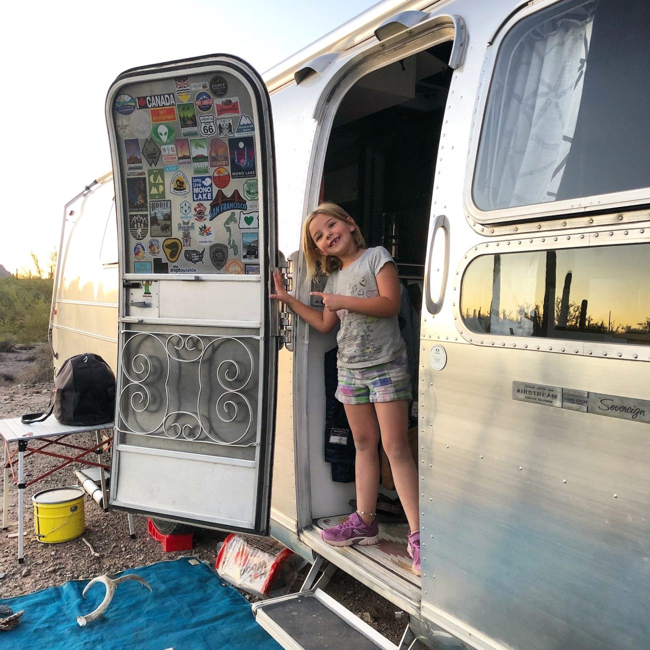 Little girl showing off missing tooth in Airstream
