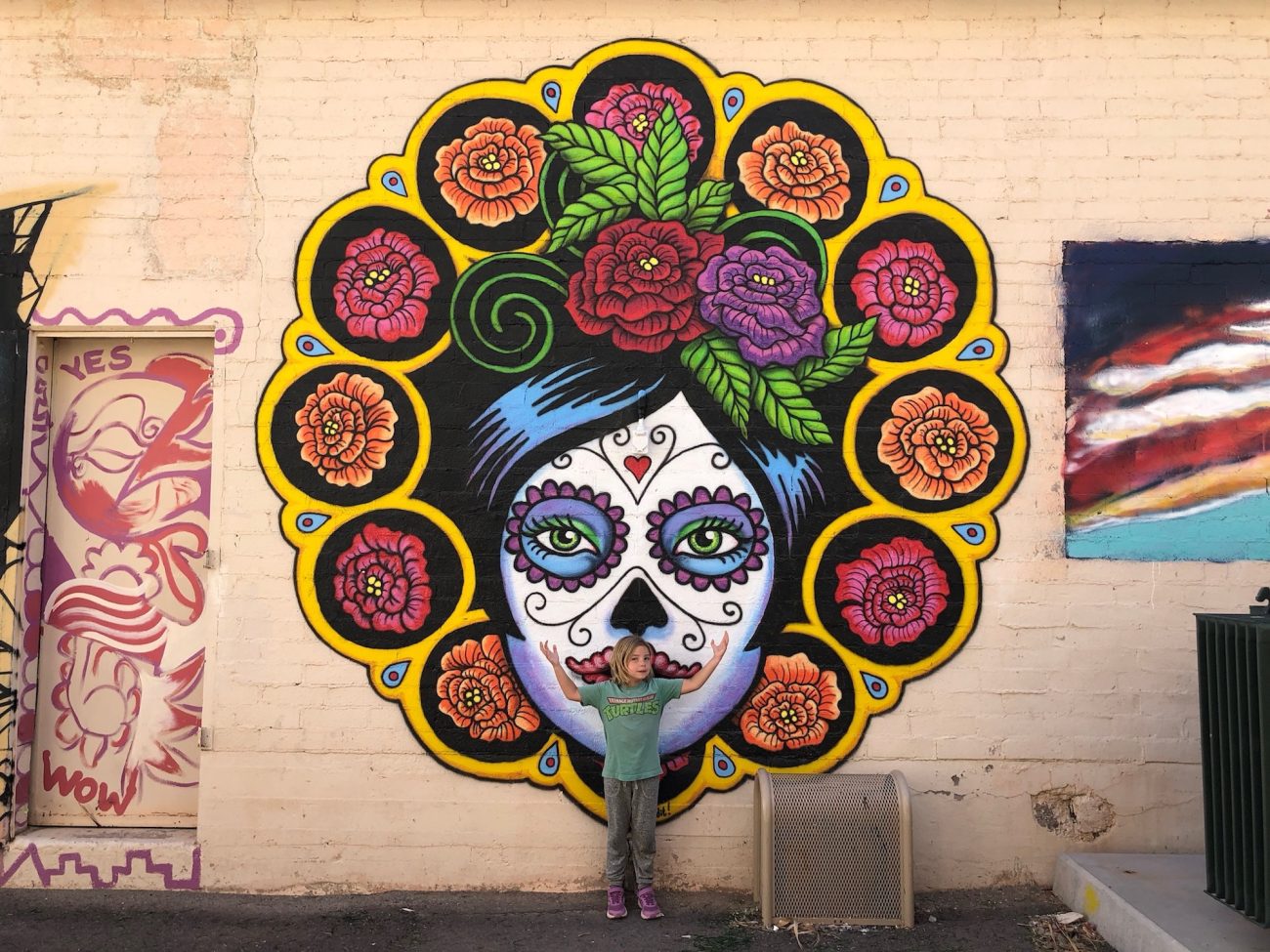 Ada standing in front of mural in downtown Ajo, AZ