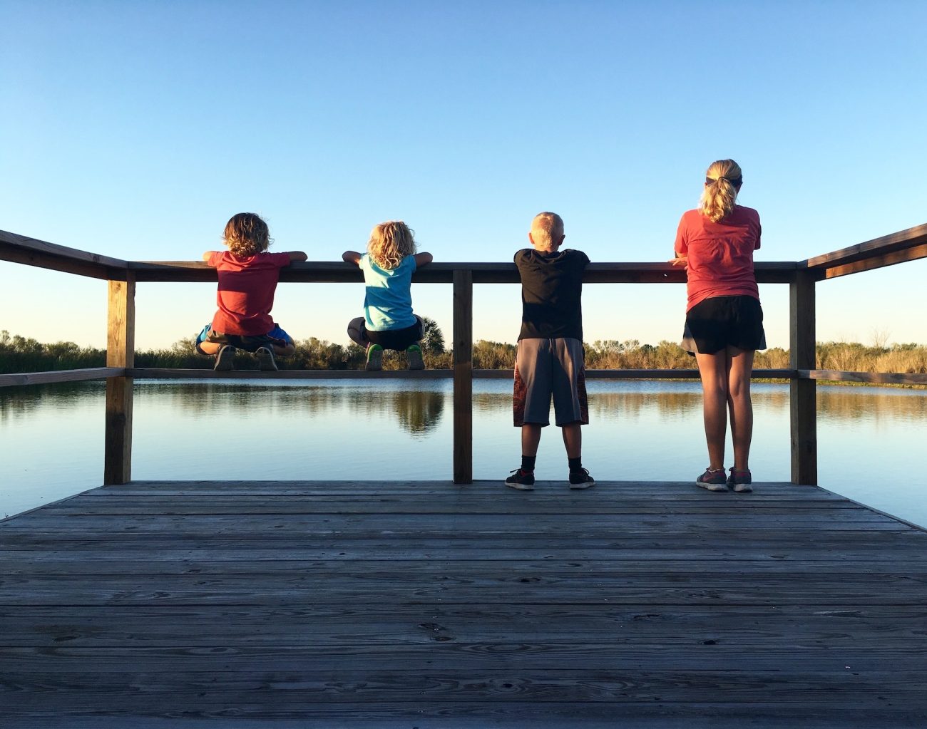 Four children overlooking pond.