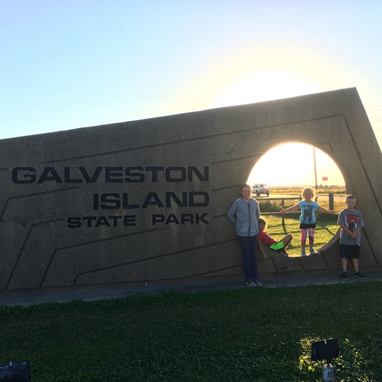 Kids at Galveston Island Sign