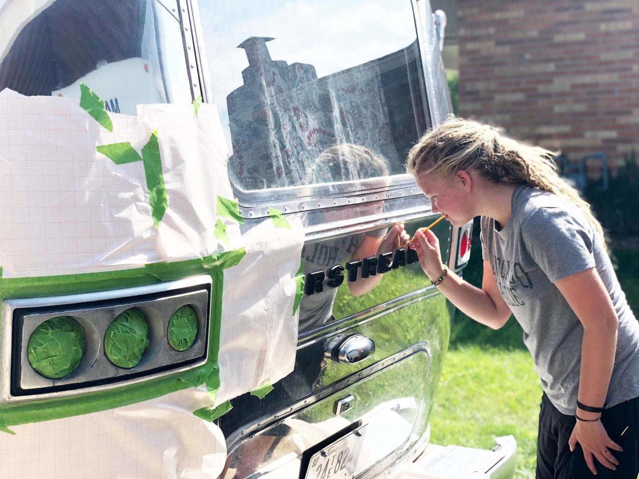 Adali touching up Paint on Airstream