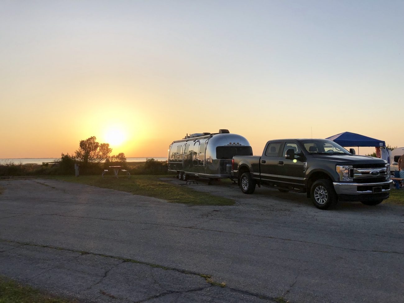 Sun goes down behind Airstream and Truck