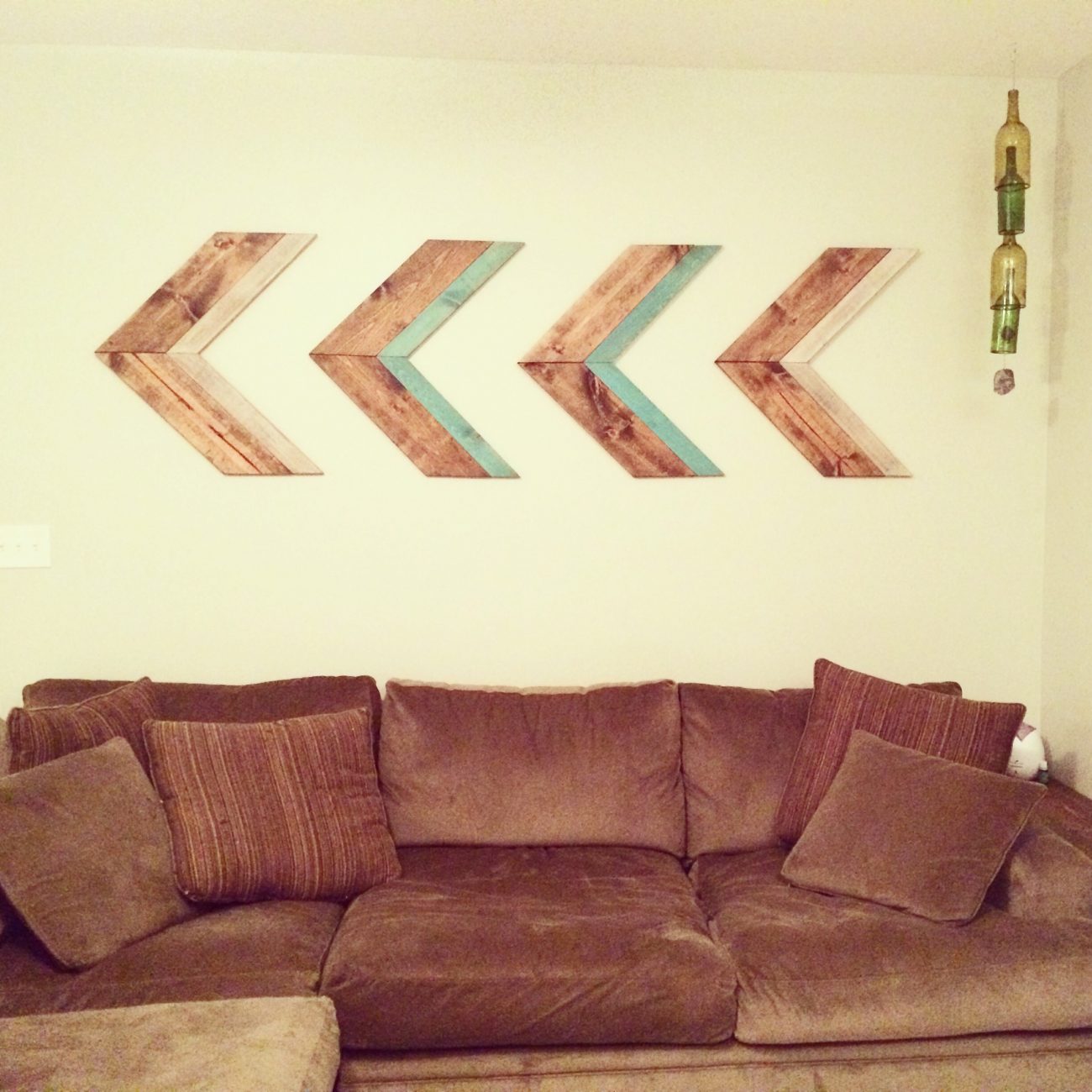 Wooden arrows above couch