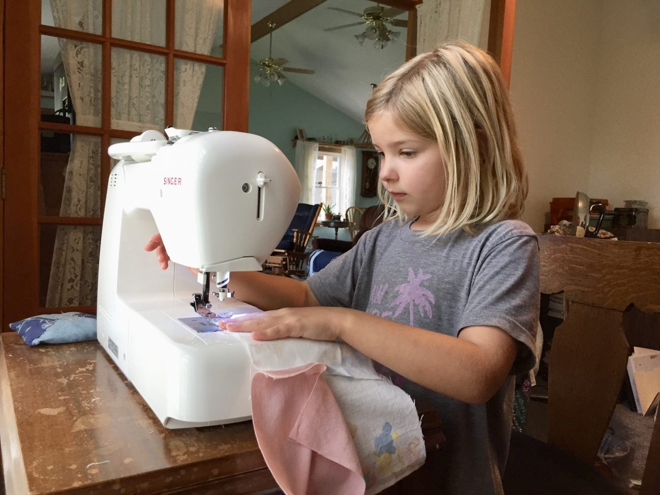 Ada learns how to sew