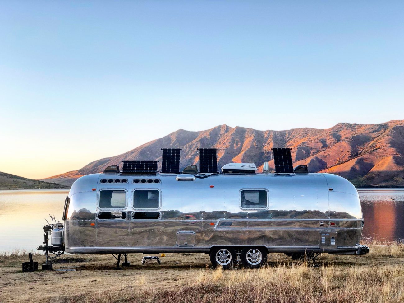 Airstream In Front of Lake at Sunset