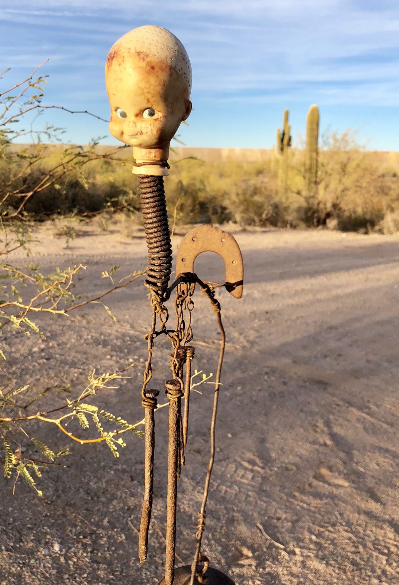 Creepy doll head on metal spring