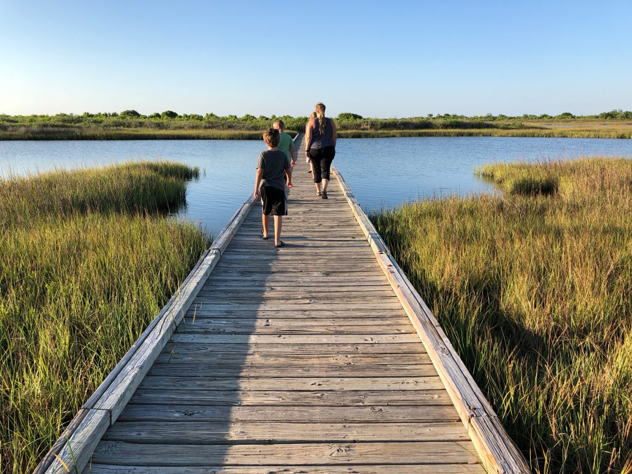Family crossing bridge at Galveston