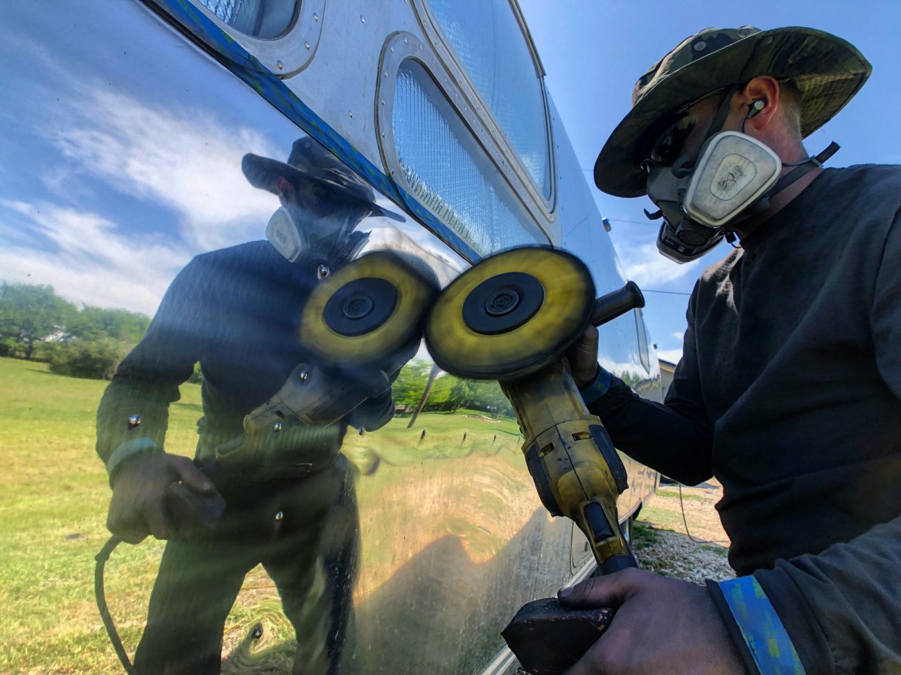 Man reflected polishing Airstream