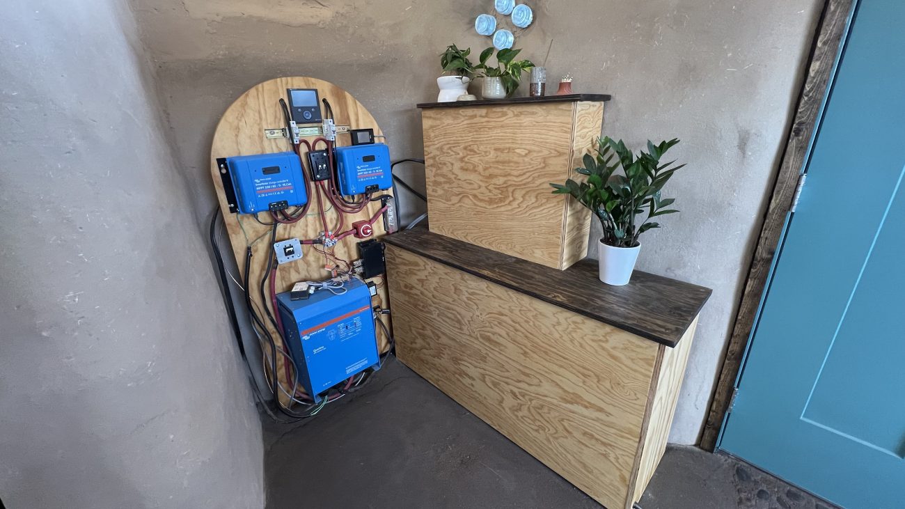 Tiny Shiny Home Solar Shed Power Corner with Battery Boxes and Breaker Panels Covered.