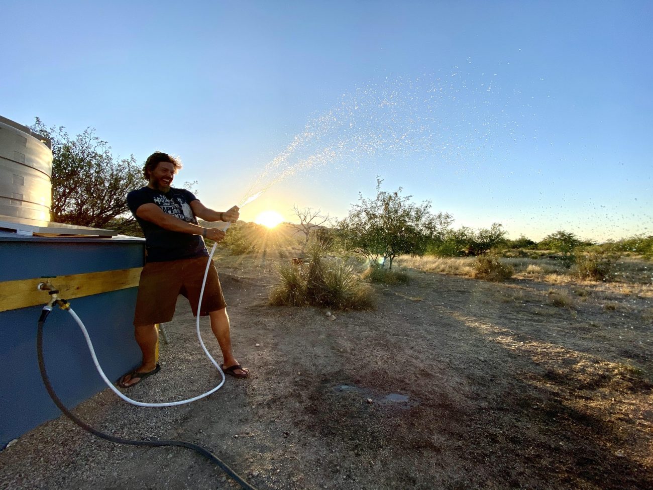 Spraying pressurized water off-grid at sunset.